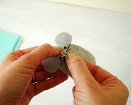 sewing on a felt plushy face
